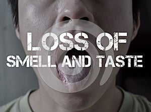 Ã¢â¬ÅLoss of Smell and TasteÃ¢â¬Âtitle with background of Asian young manÃ¢â¬â¢s nose and mouth. Concept of anosmia and ageusia. Symptoms photo